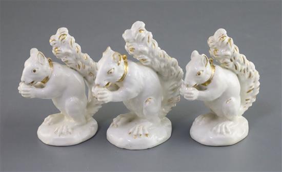 Three Derby porcelain figures of a squirrel, c.1800-30, H. 8.2cm and 9.2cm, faults